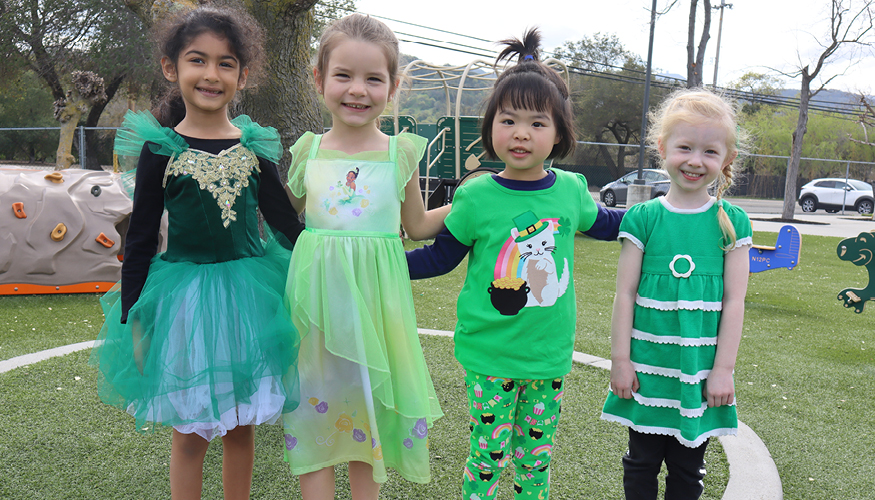 Four young Challenger students wearing green for St. Patrick’s Day