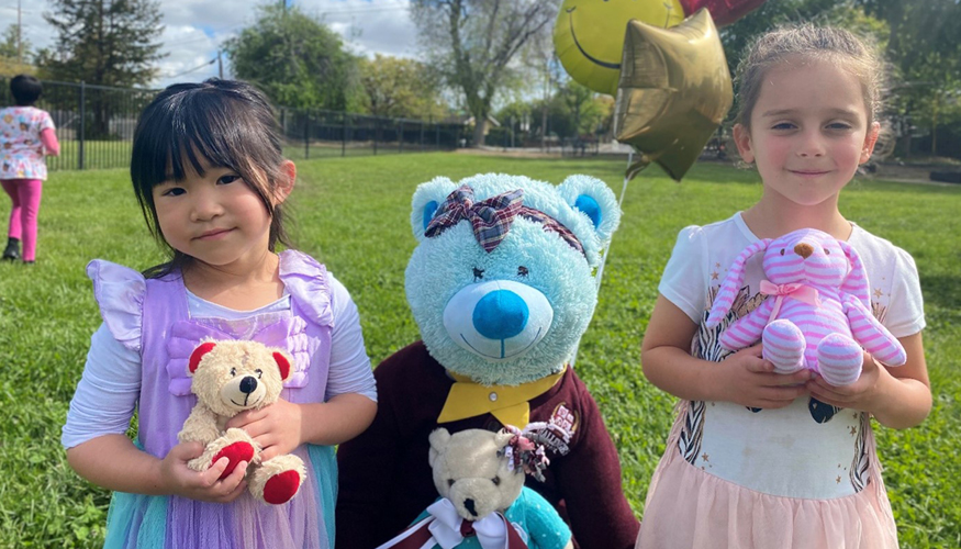 Two Challenger kindergartners holding stuffed animals for Teddy Bear Picnic