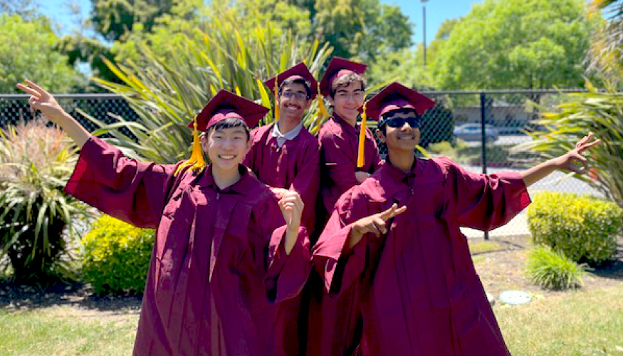 Four Challenger graduates wearing their cap and gown