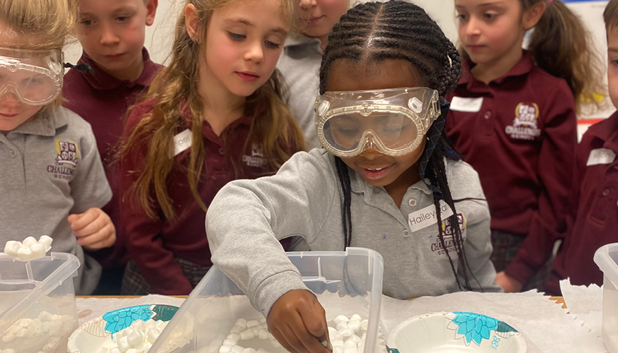 Smiling Challenger students with their Science Fair project