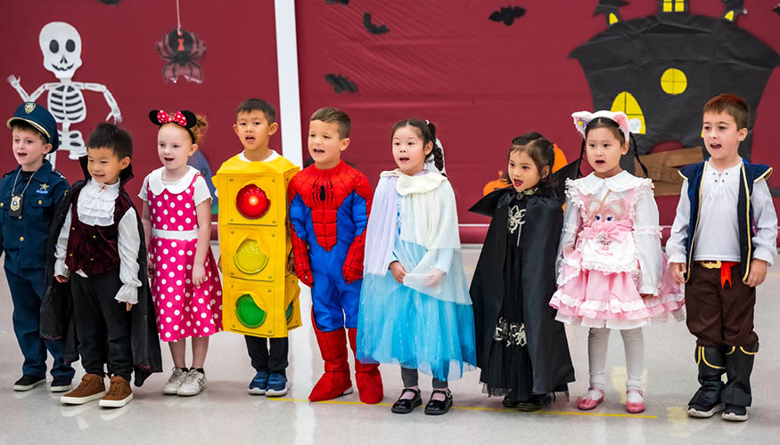 Happy students wearing Halloween costumes and participating in the Halloween event